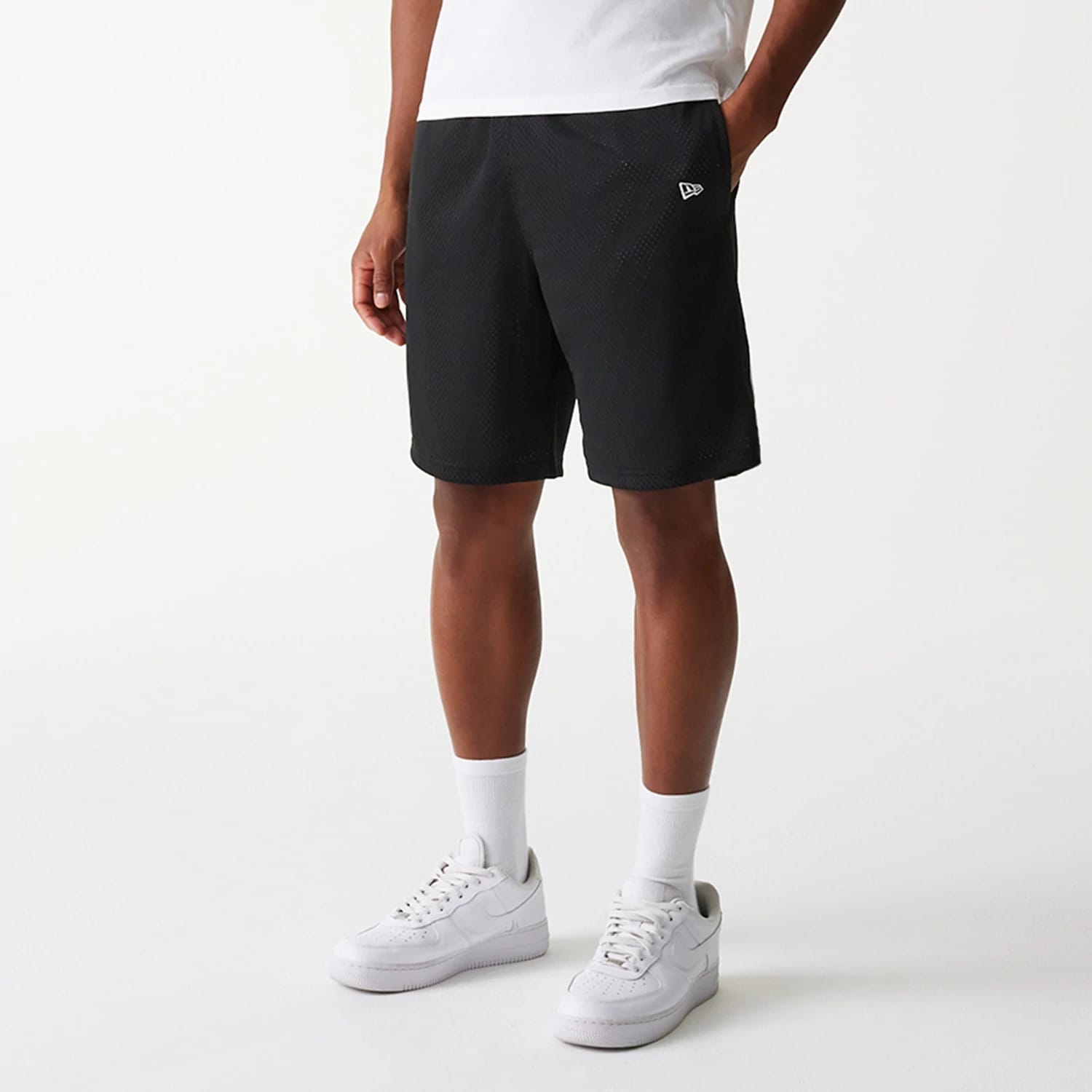 The Male model is wearing New Era Black Mesh Shorts 3