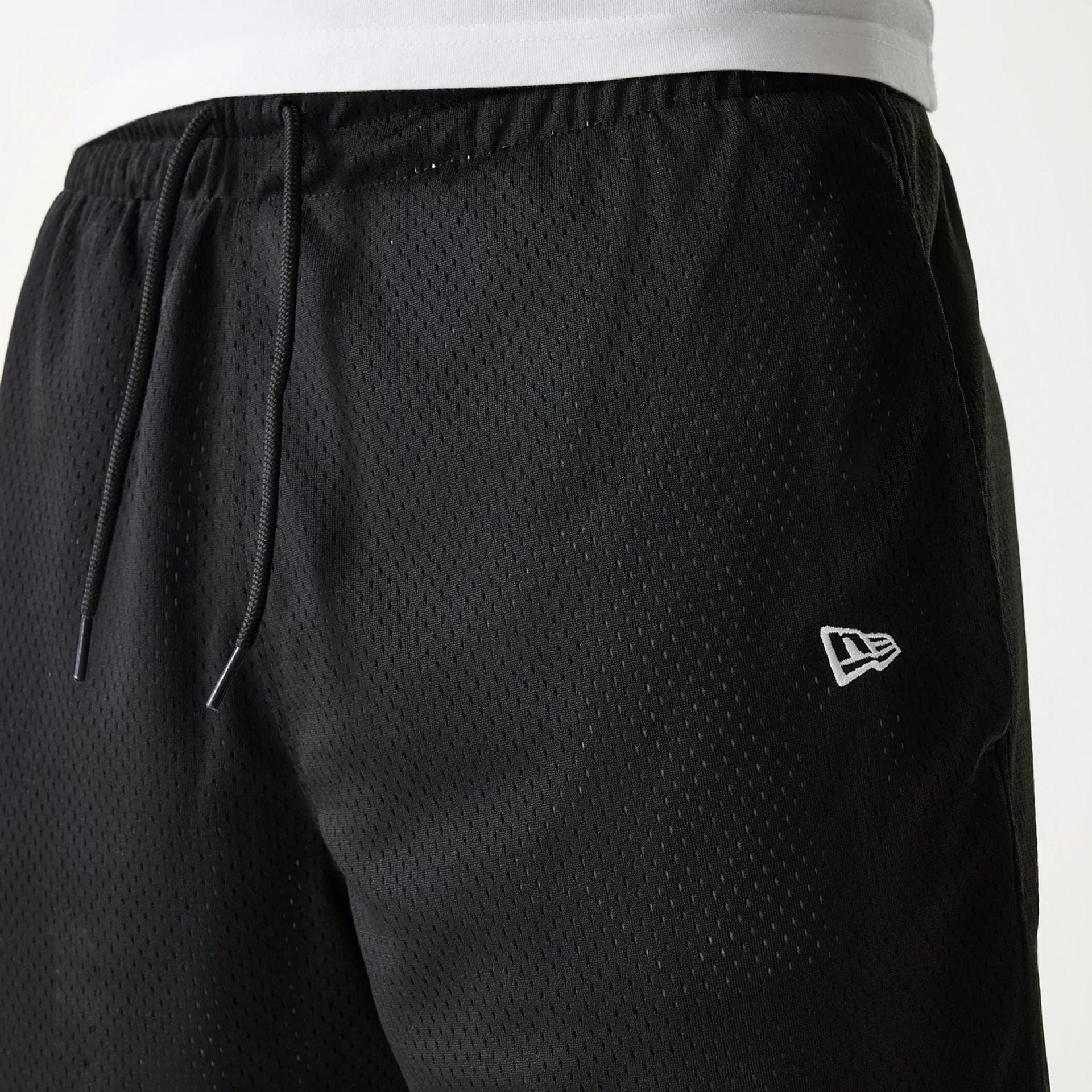 The Male model is wearing New Era Black Mesh Shorts 4
