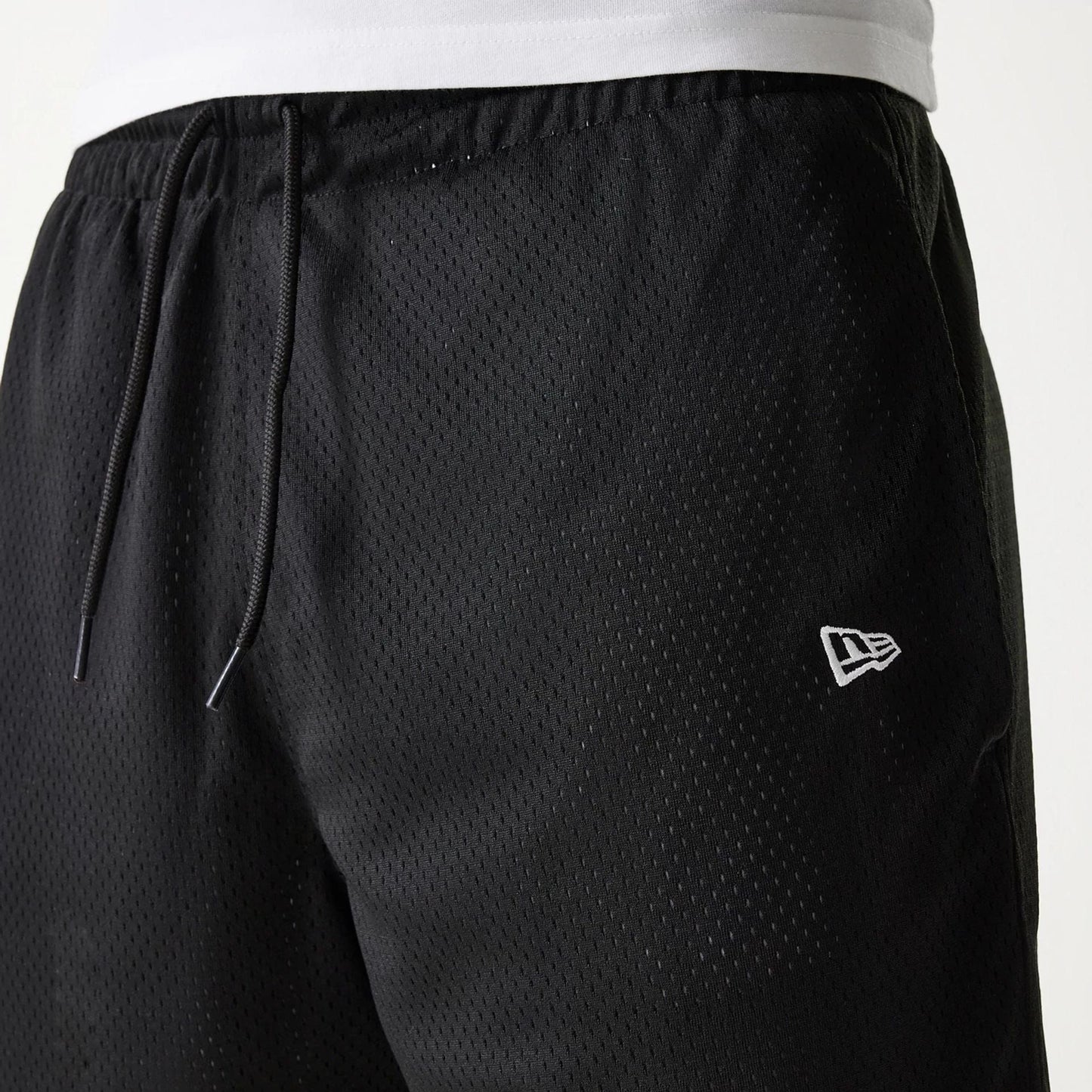 The Male model is wearing New Era Black Mesh Shorts 4