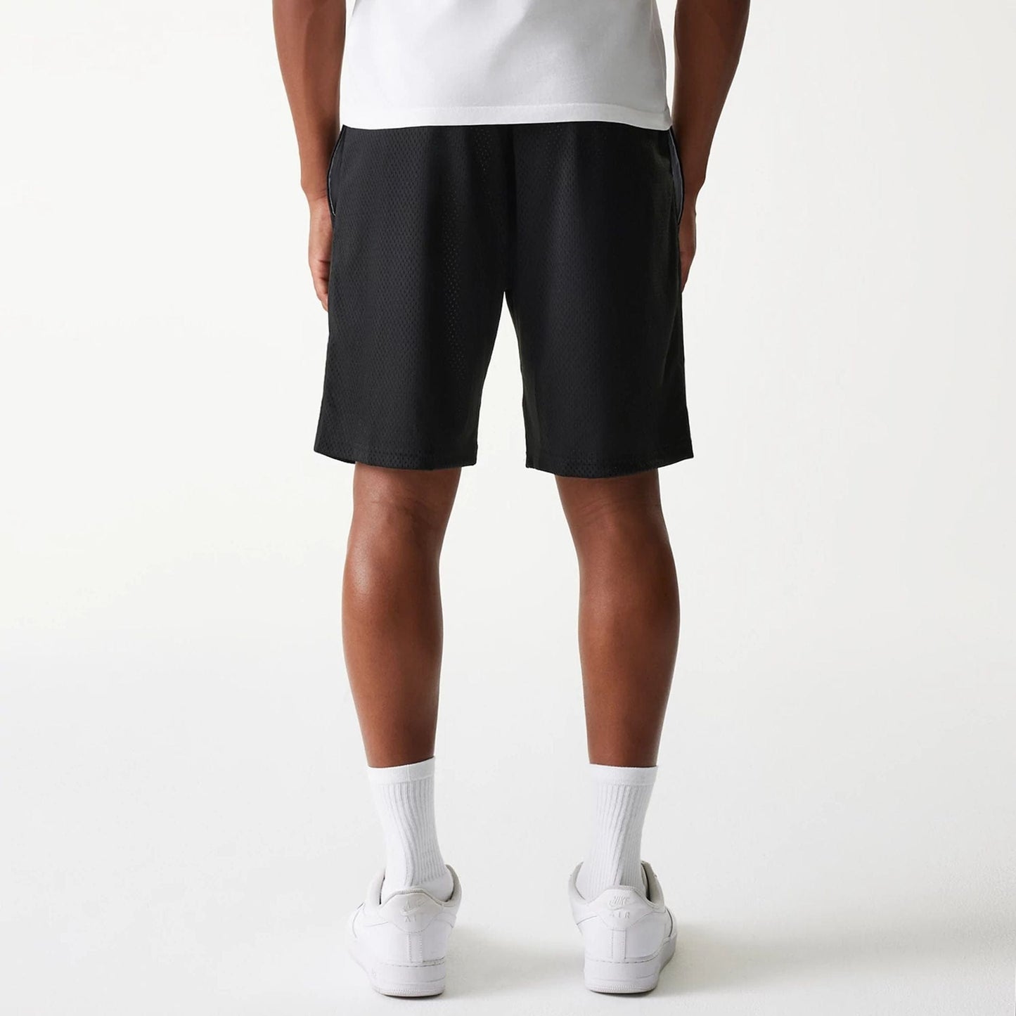 The Male model is wearing New Era Black Mesh Shorts 2