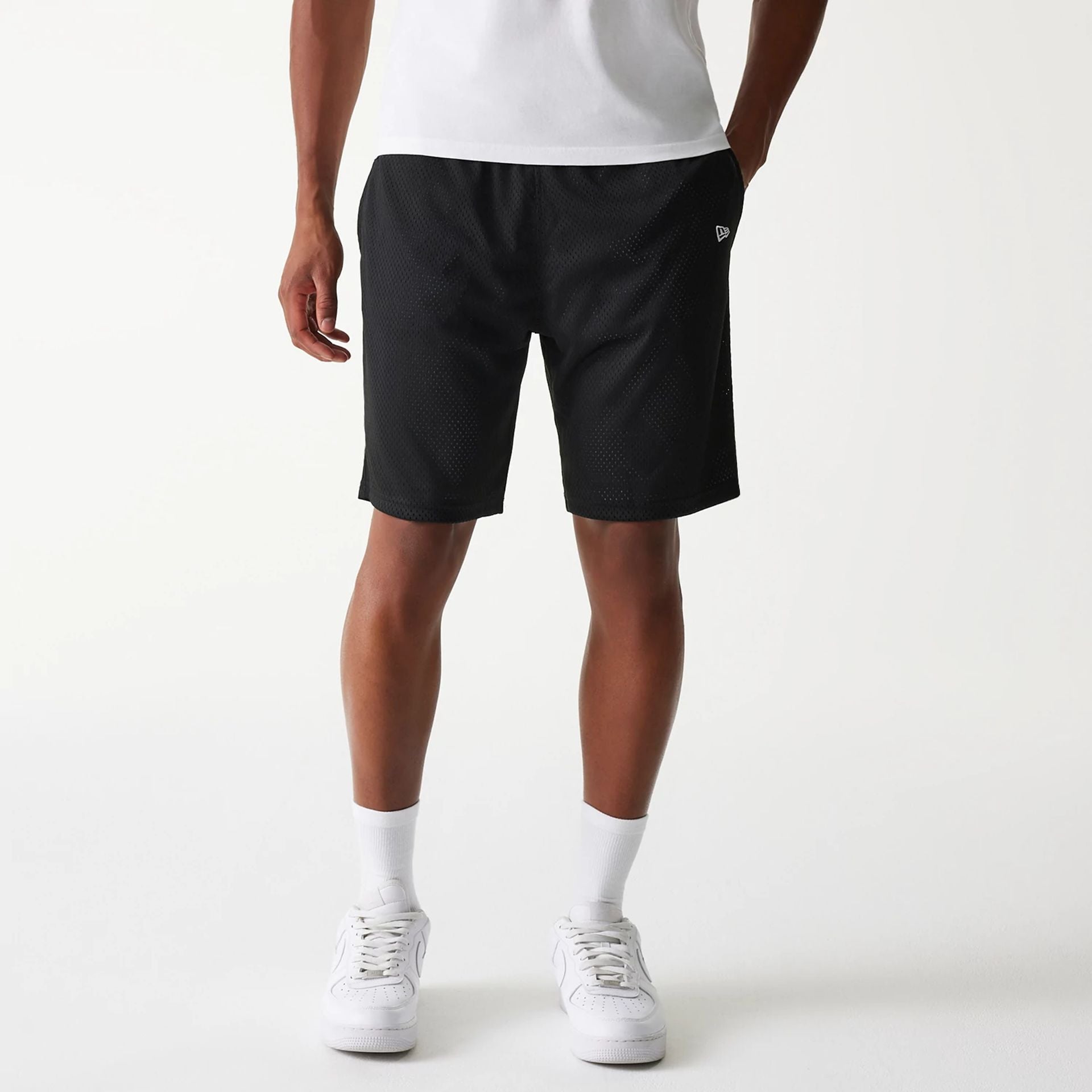 The Male model is wearing New Era Black Mesh Shorts 1