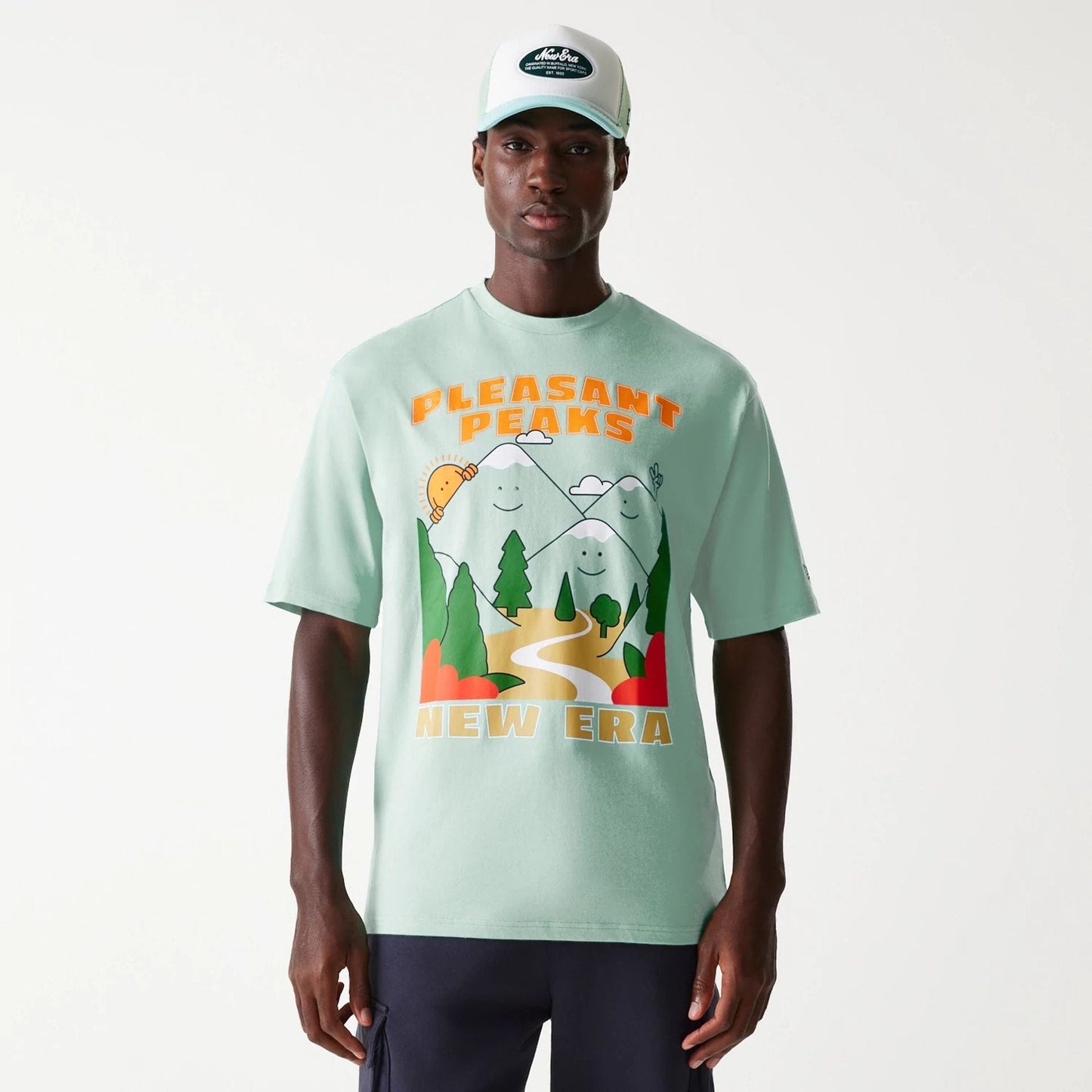 The Male model is wearing New Era Outdoor Graphic Pastel Green Oversized T-Shirt 1