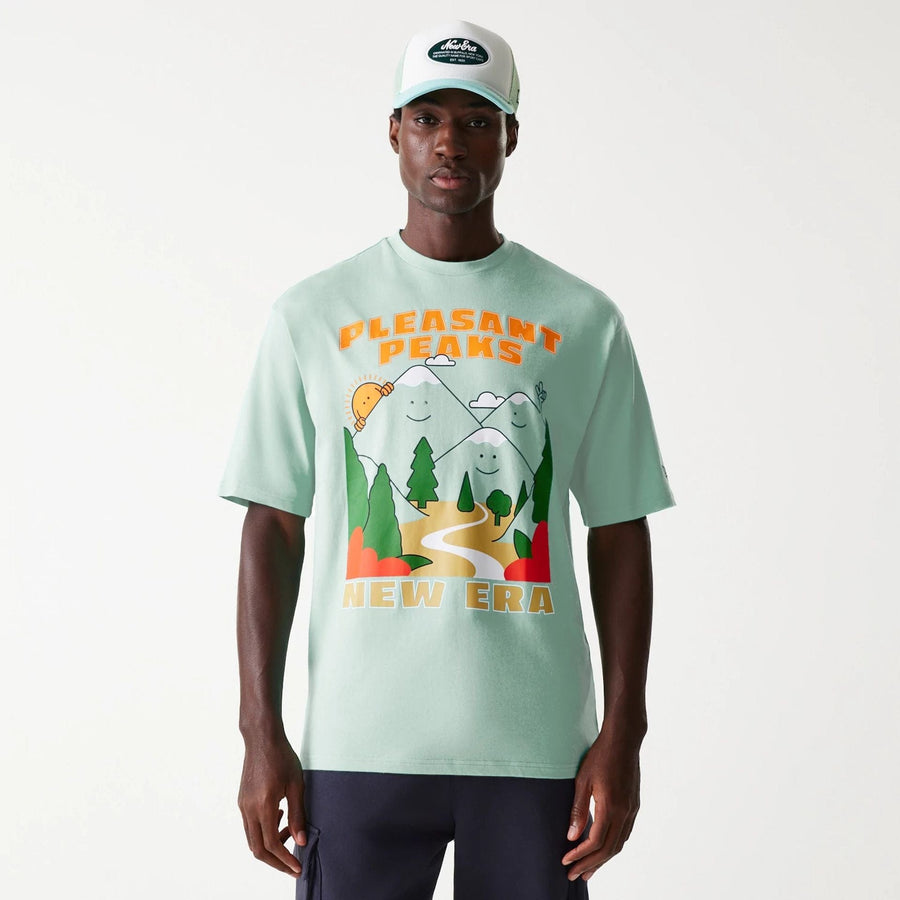 The Male model is wearing New Era Outdoor Graphic Pastel Green Oversized T-Shirt 1