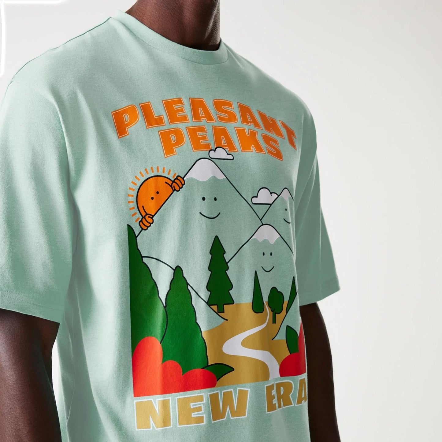The Male model is wearing New Era Outdoor Graphic Pastel Green Oversized T-Shirt 3