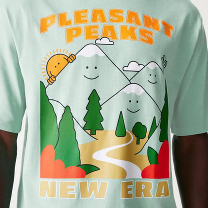 The Male model is wearing New Era Outdoor Graphic Pastel Green Oversized T-Shirt 4