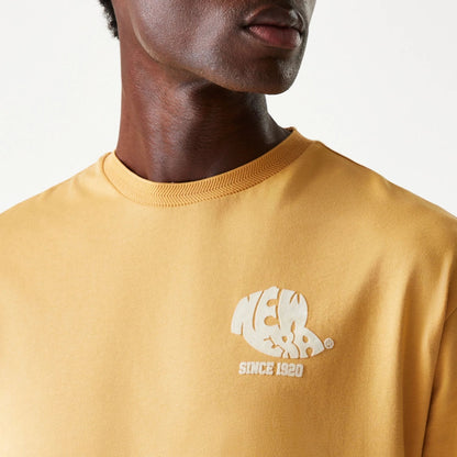 The Male model is wearing New Era Graphic Beige Oversized T-Shirt 7