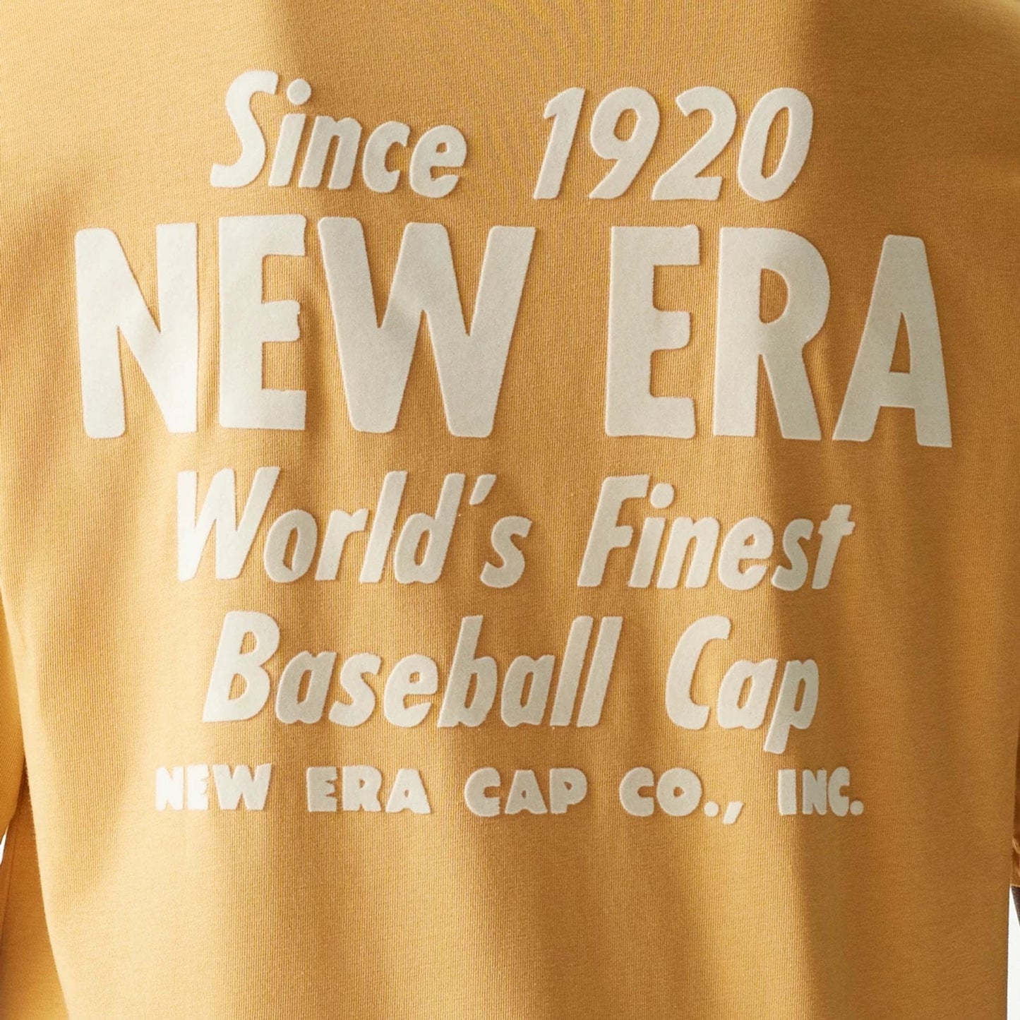 The Male model is wearing New Era Graphic Beige Oversized T-Shirt 4