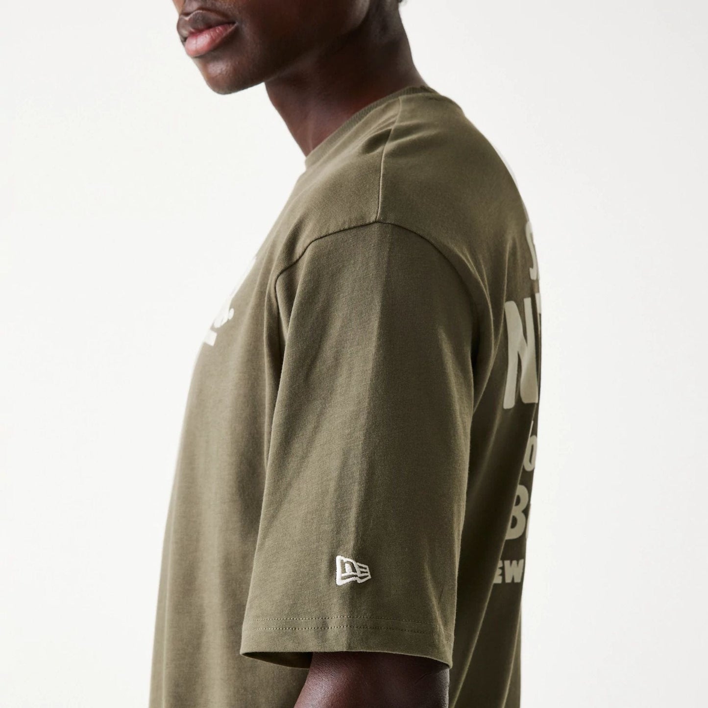 The Male model is wearing New Era Graphic Green Oversized T-Shirt 5