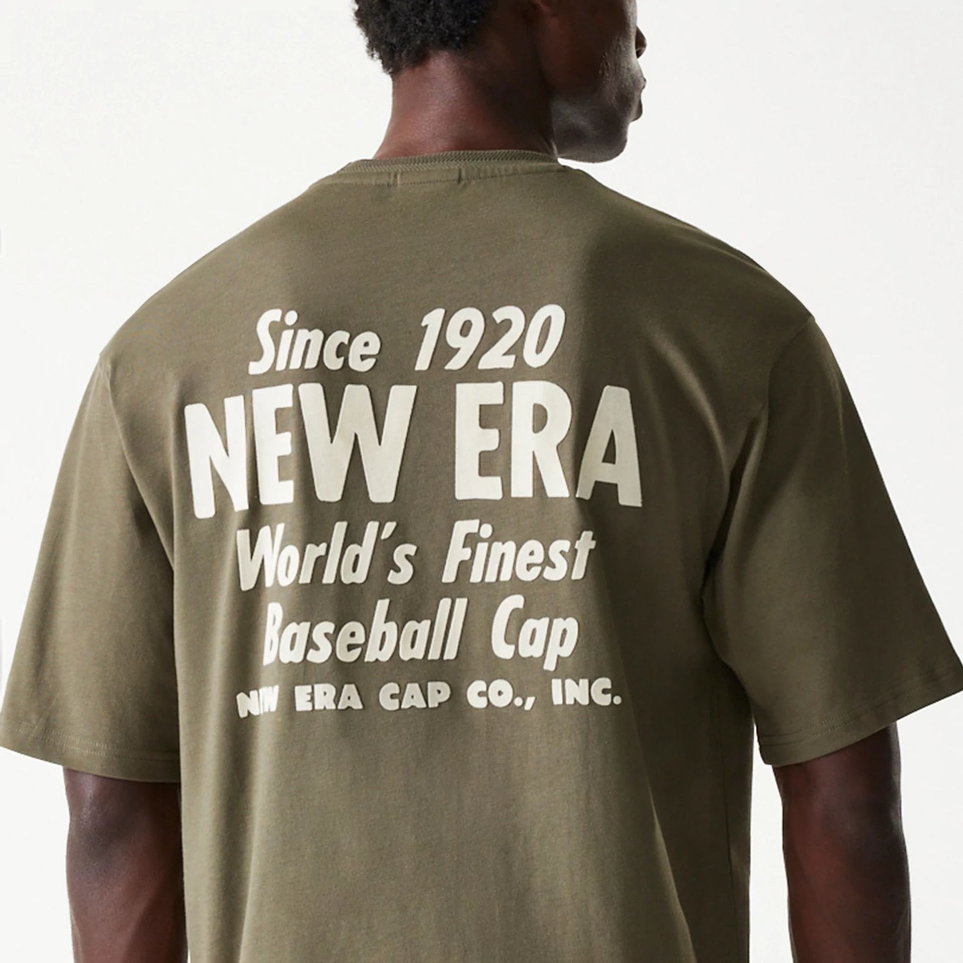 The Male model is wearing New Era Graphic Green Oversized T-Shirt 4