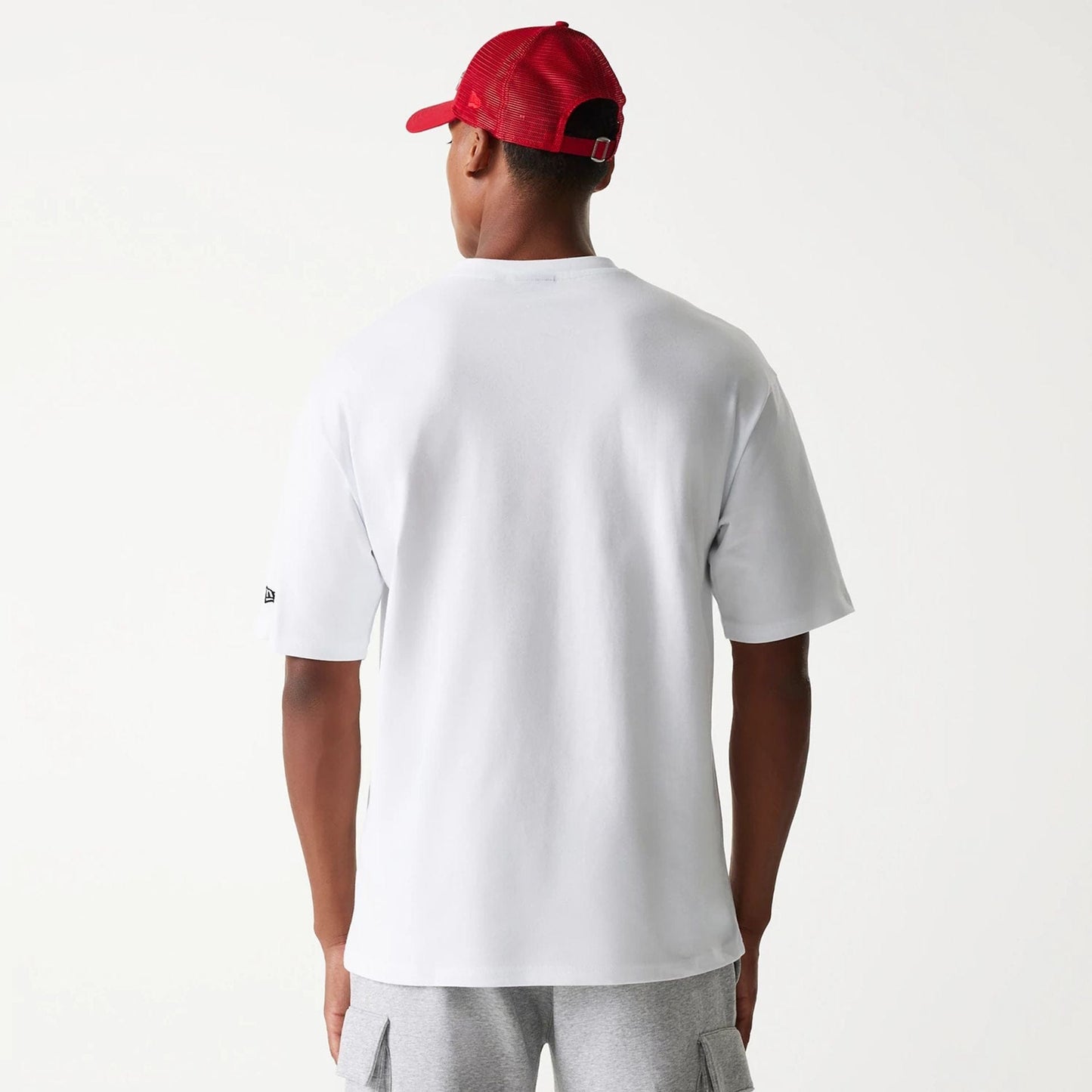 The Male model is wearing New Era Outdoor Graphic White Oversized T-Shirt 2