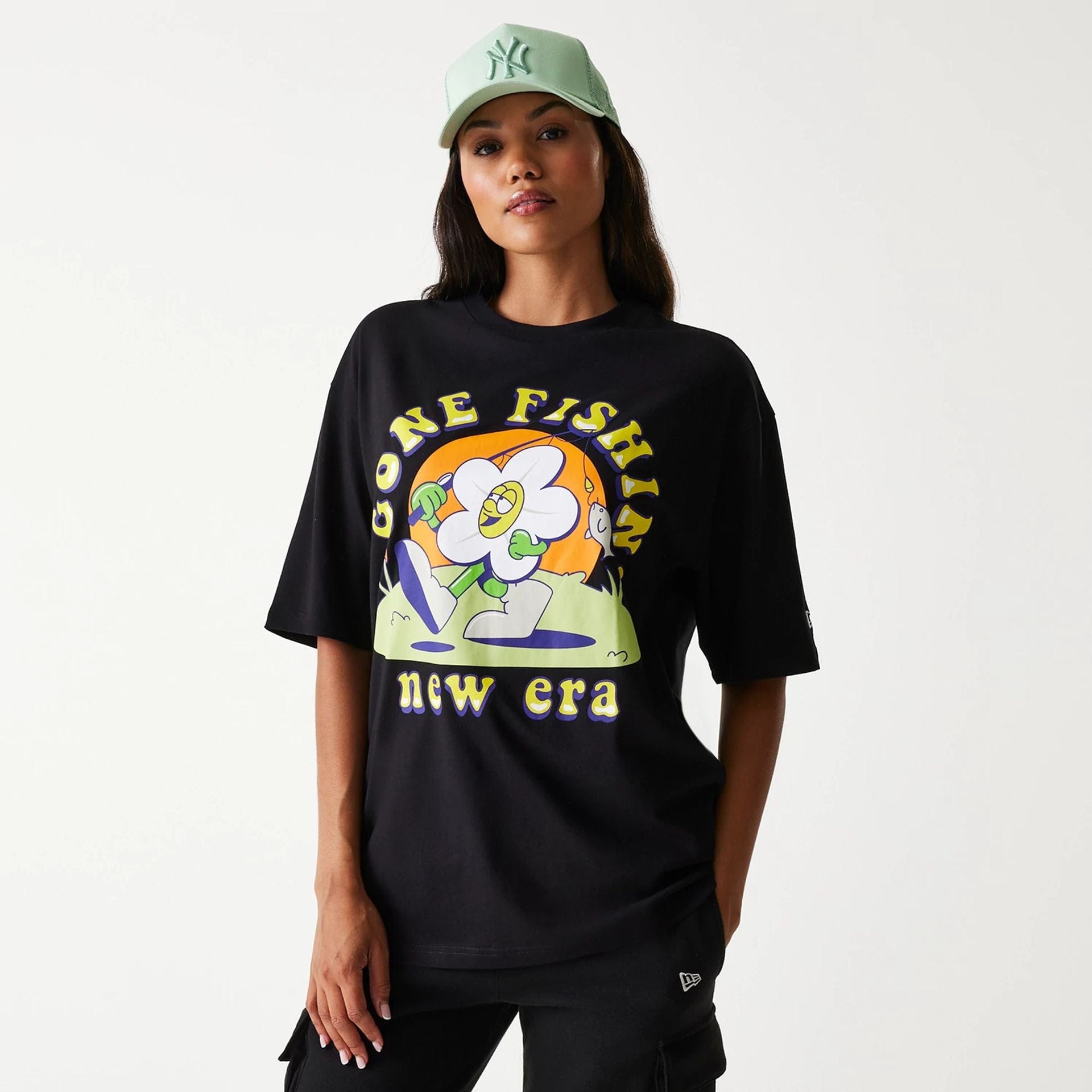 The Male model is wearing New Era Outdoor Graphic Black Oversized T-Shirt 4