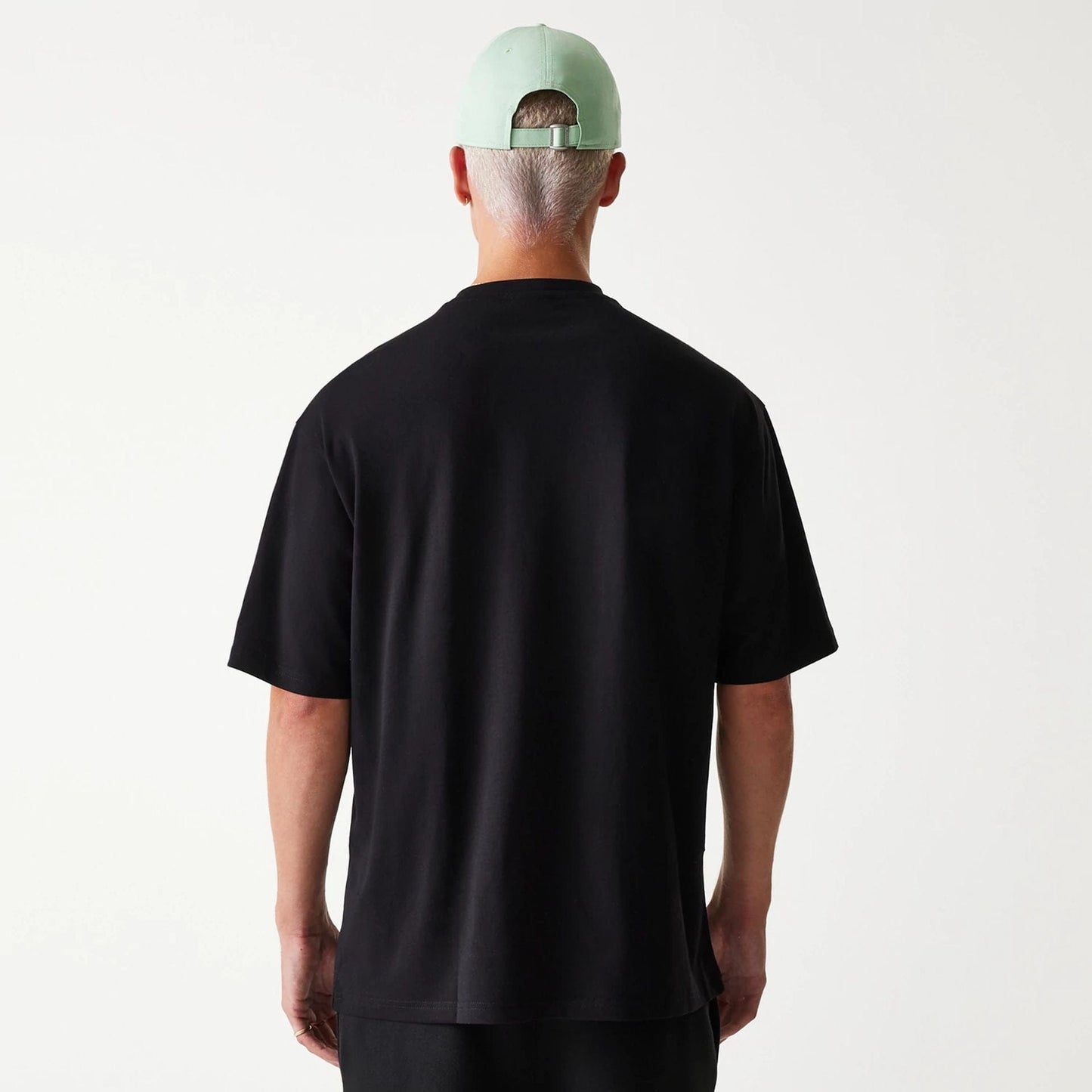 The Male model is wearing New Era Outdoor Graphic Black Oversized T-Shirt 2