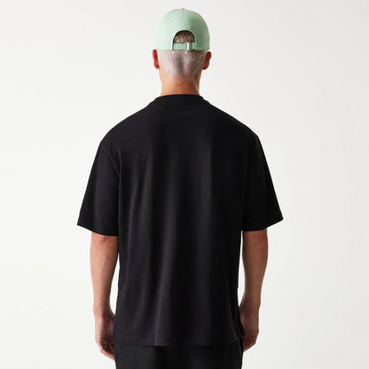 The Male model is wearing New Era Outdoor Graphic Black Oversized T-Shirt 2