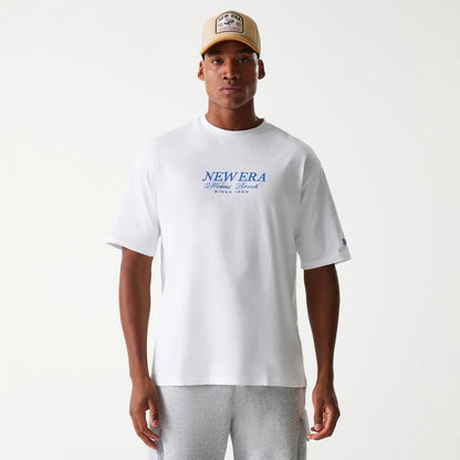 The Male model is wearing New Era Vacation Graphic White Oversized T-Shirt 2