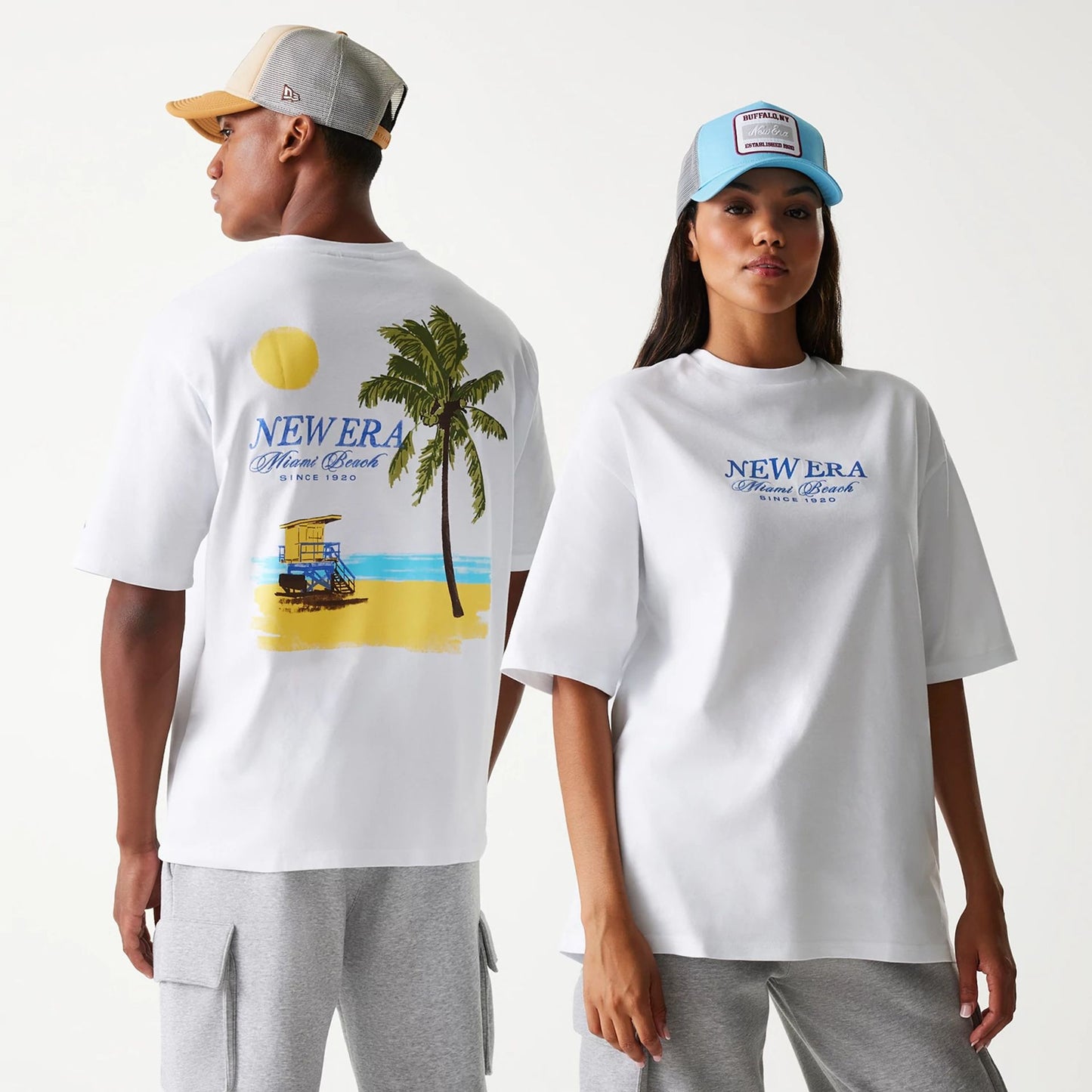 The Male model is wearing New Era Vacation Graphic White Oversized T-Shirt 1