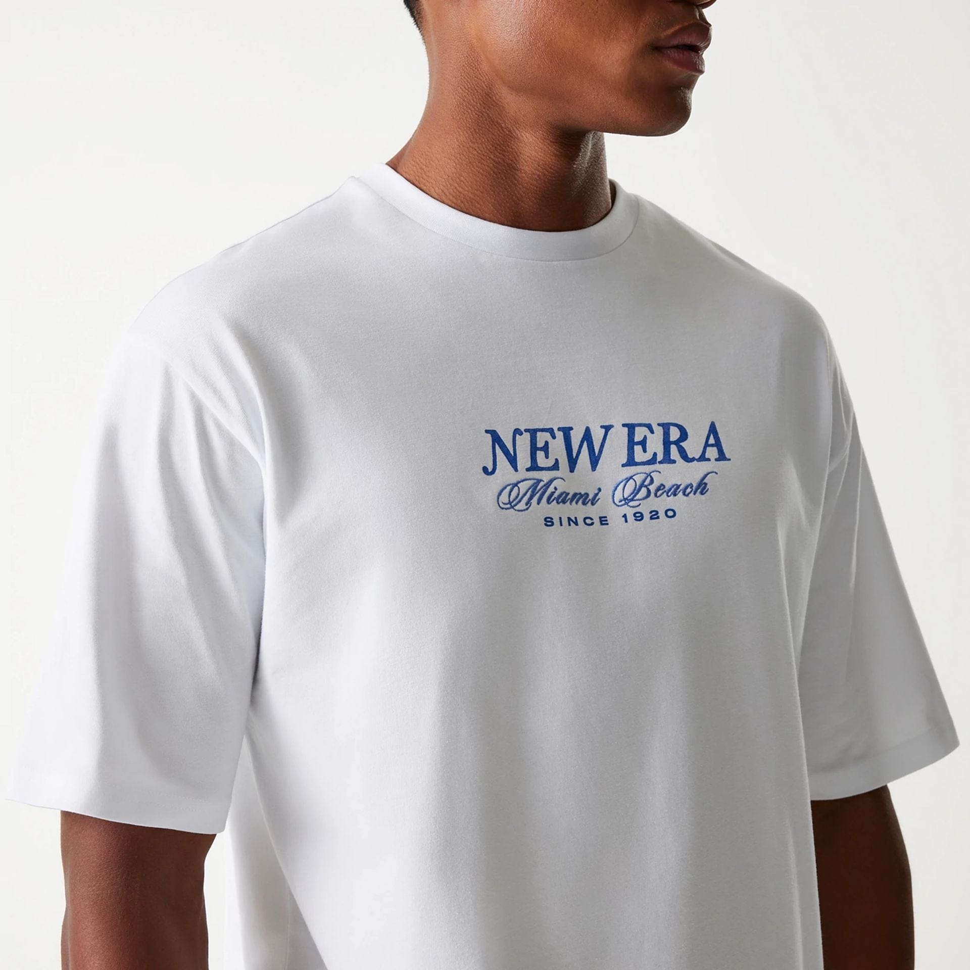 The Male model is wearing New Era Vacation Graphic White Oversized T-Shirt 6