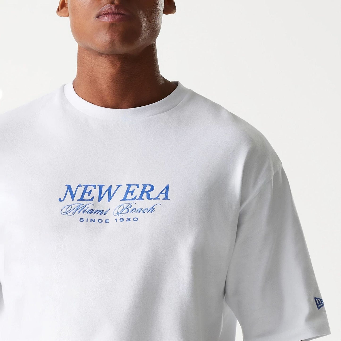 The Male model is wearing New Era Vacation Graphic White Oversized T-Shirt 7