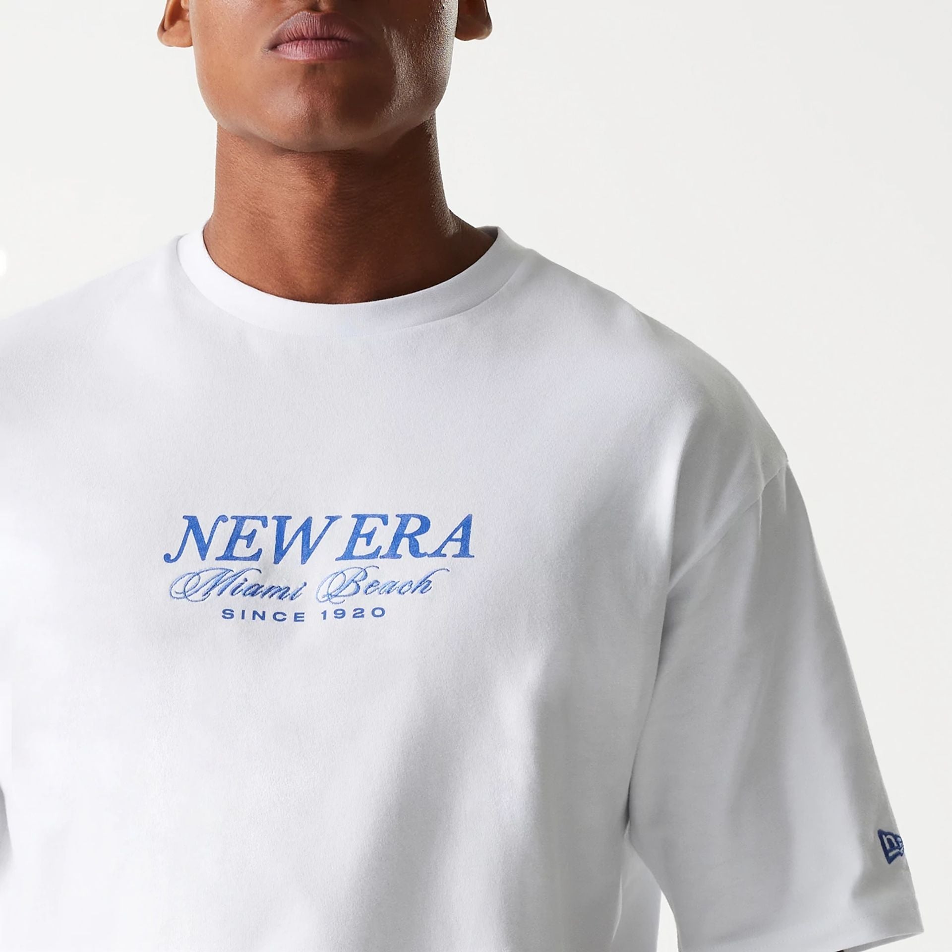 The Male model is wearing New Era Vacation Graphic White Oversized T-Shirt 7