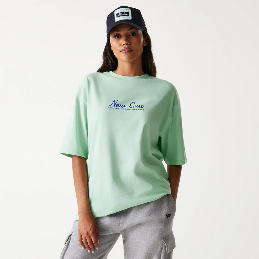 The Male model is wearing New Era Vacation Graphic Pastel Green Oversized T-Shirt 4
