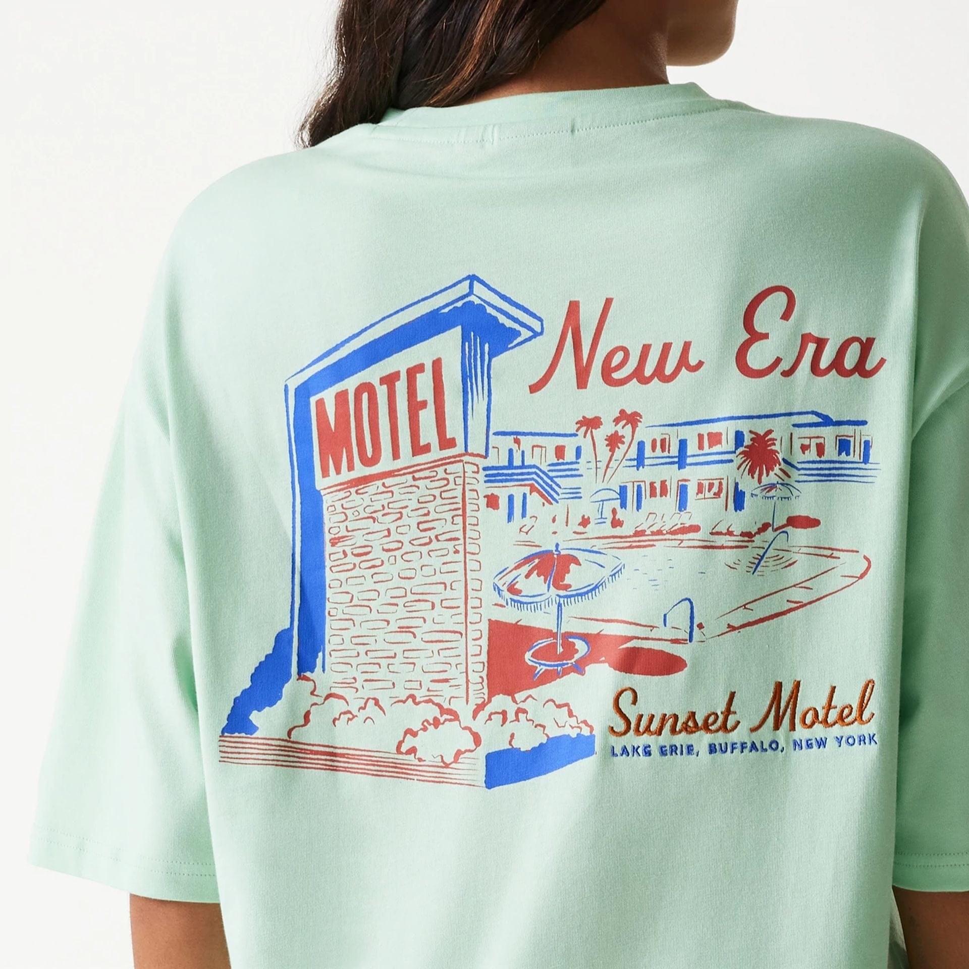 The Male model is wearing New Era Vacation Graphic Pastel Green Oversized T-Shirt 5