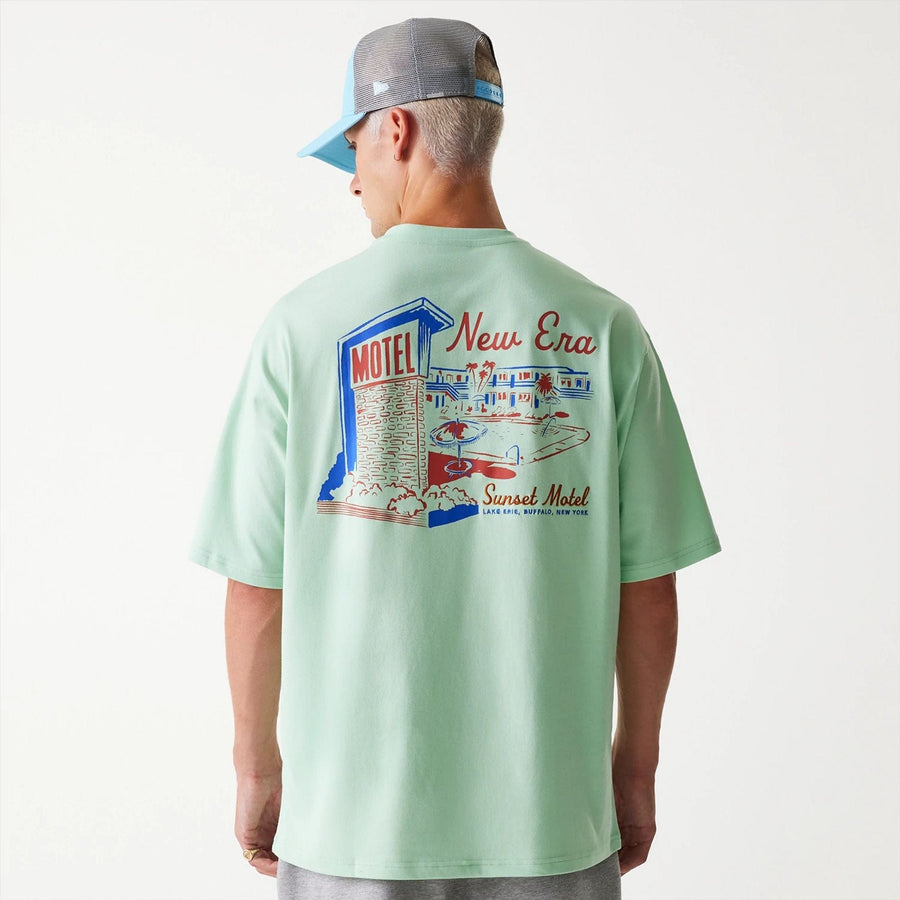 The Male model is wearing New Era Vacation Graphic Pastel Green Oversized T-Shirt 3