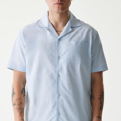 The Male model is wearing New Era Pastel Blue Revere Short Sleeve Shirt 3