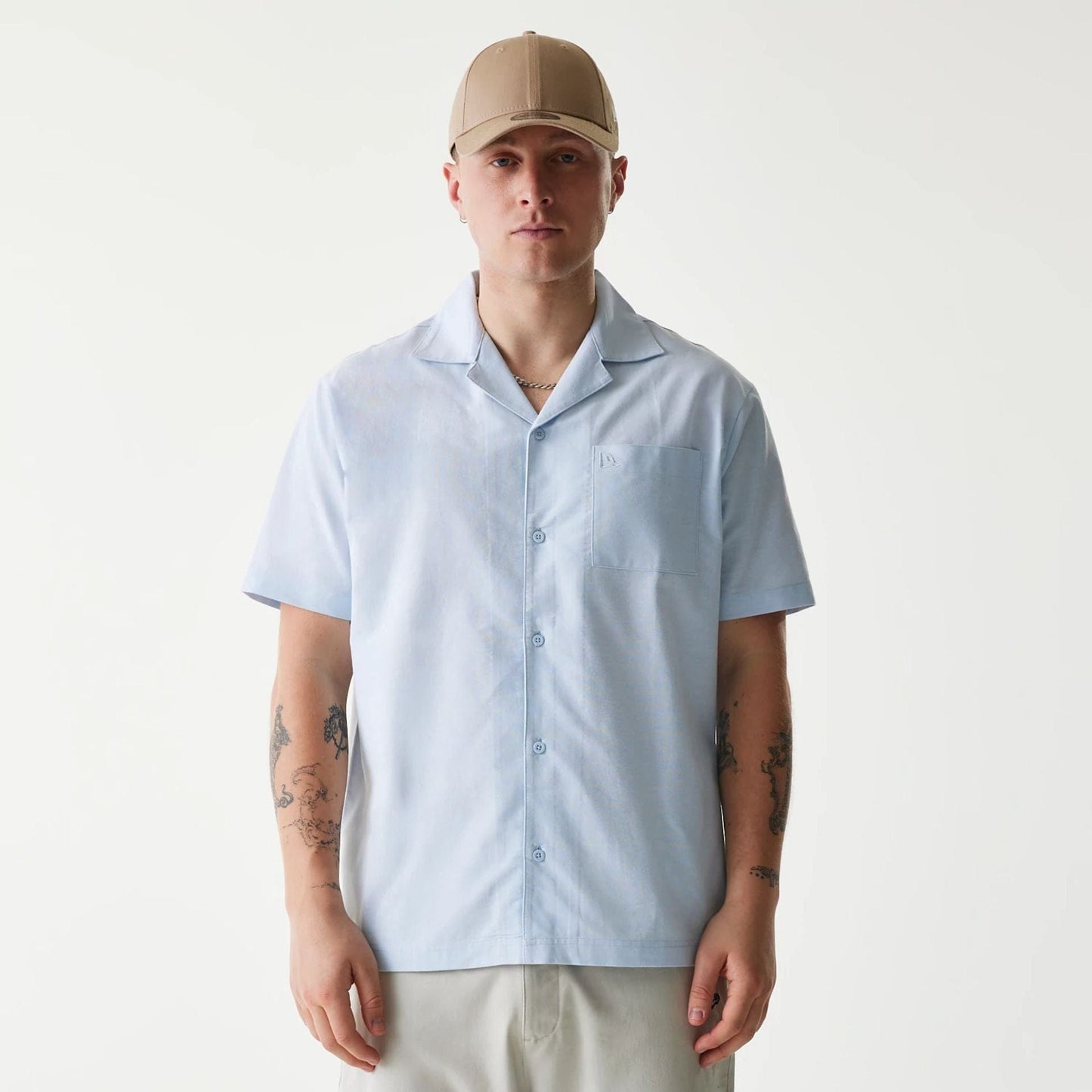 The Male model is wearing New Era Pastel Blue Revere Short Sleeve Shirt 1