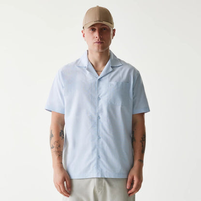 The Male model is wearing New Era Pastel Blue Revere Short Sleeve Shirt 1