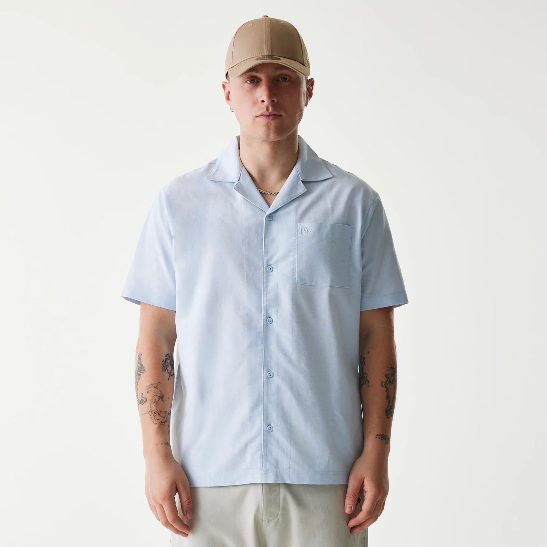 The Male model is wearing New Era Pastel Blue Revere Short Sleeve Shirt 1