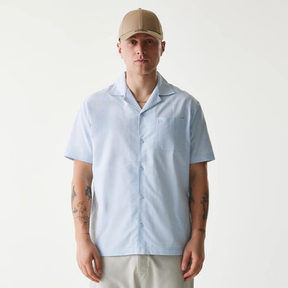 The Male model is wearing New Era Pastel Blue Revere Short Sleeve Shirt 1