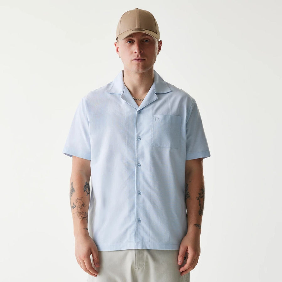 The Male model is wearing New Era Pastel Blue Revere Short Sleeve Shirt 1