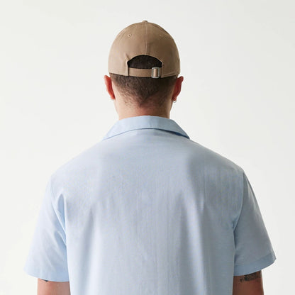 The Male model is wearing New Era Pastel Blue Revere Short Sleeve Shirt 7