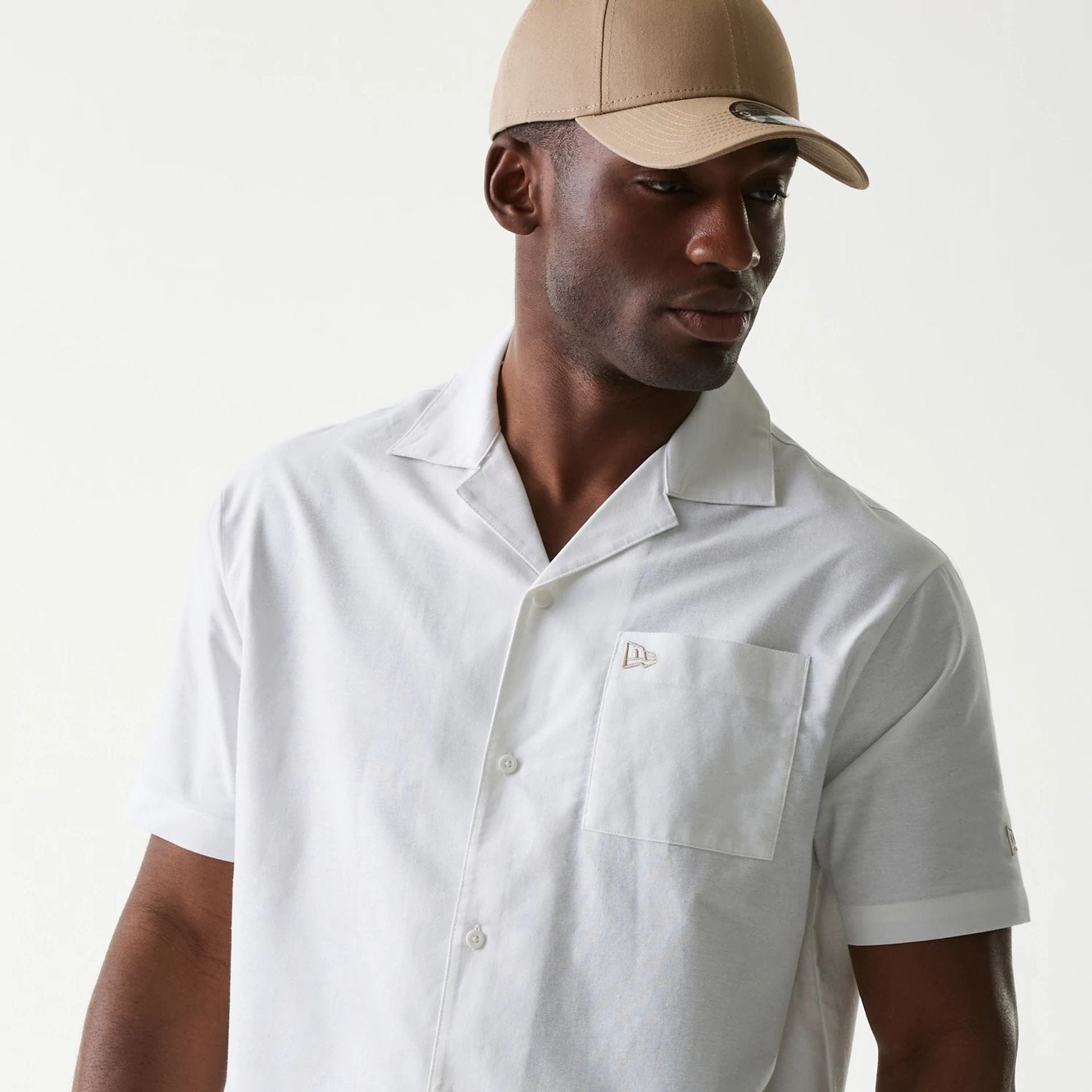 The Male model is wearing New Era White Revere Short Sleeve Shirt 3