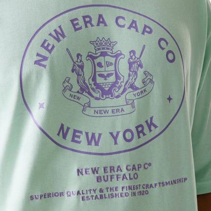 The Male model is wearing New Era Crest Pastel Green Oversized T-Shirt 4