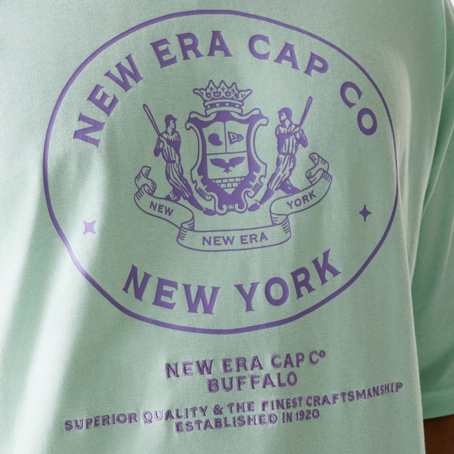 The Male model is wearing New Era Crest Pastel Green Oversized T-Shirt 4