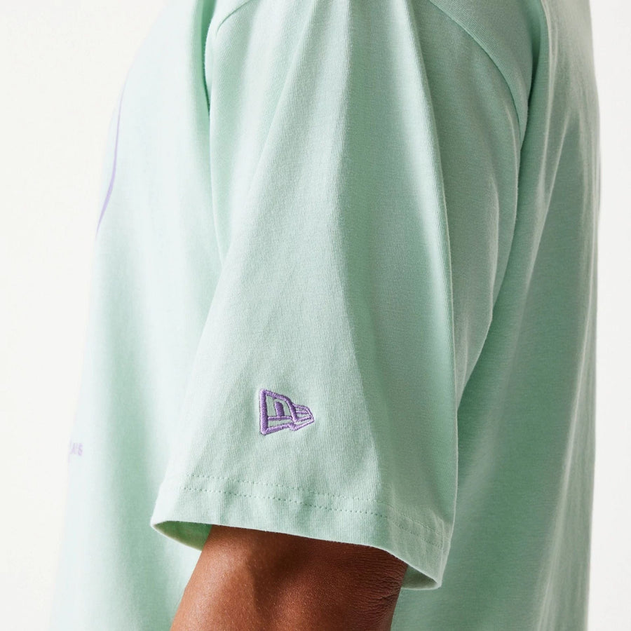 The Male model is wearing New Era Crest Pastel Green Oversized T-Shirt 5