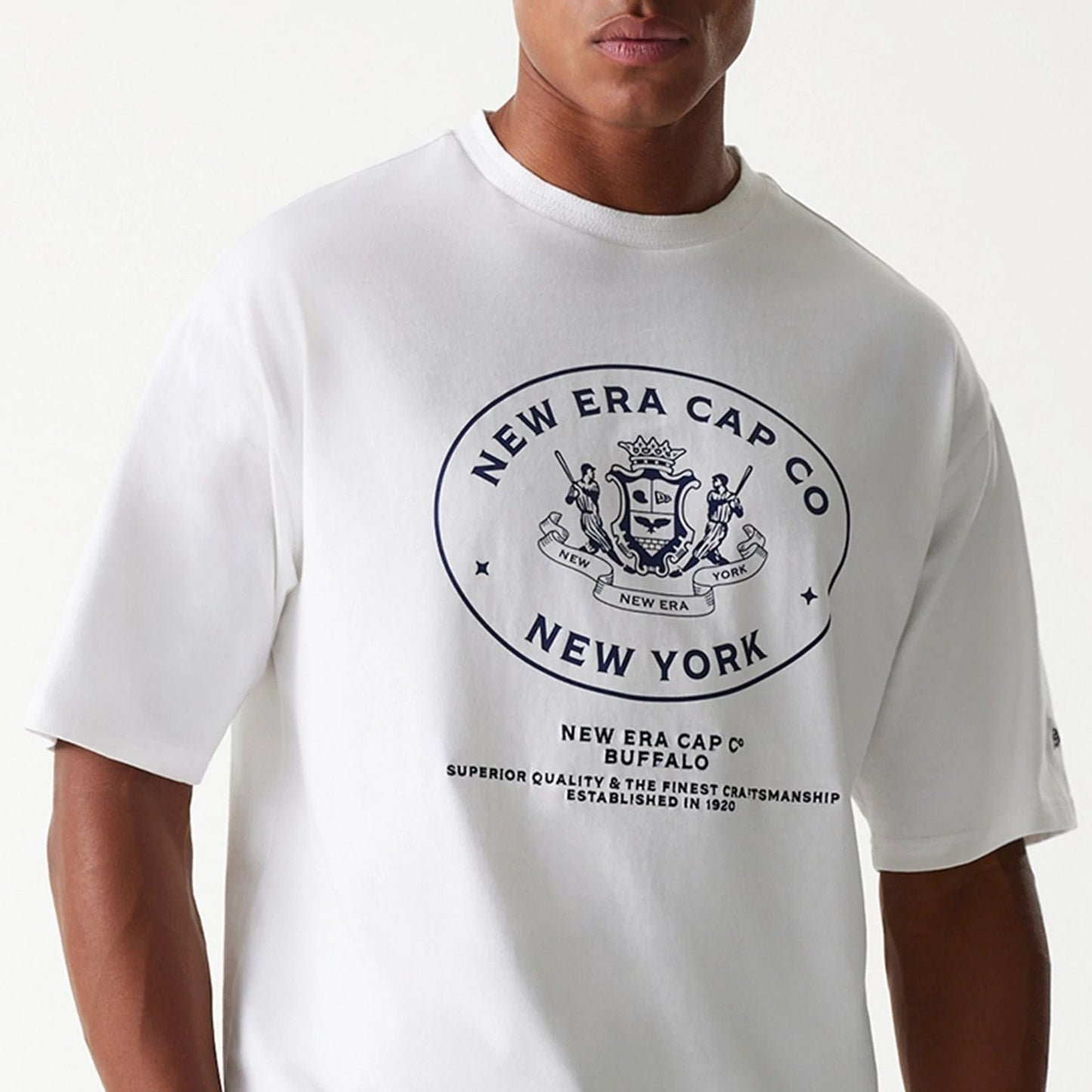 The Male model is wearing New Era Crest White Oversized T-Shirt 3
