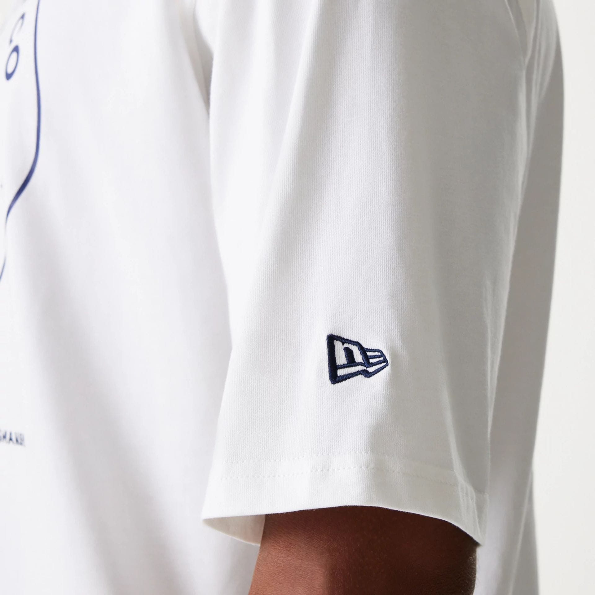 The Male model is wearing New Era Crest White Oversized T-Shirt 6