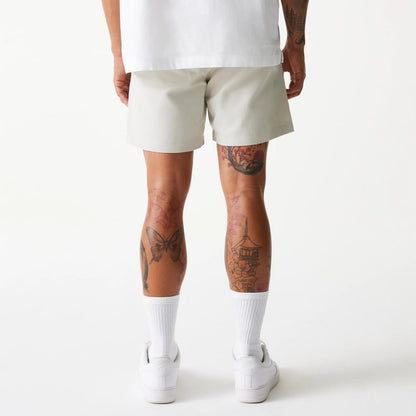 The Male model is wearing New Era Cream Chino Shorts 6