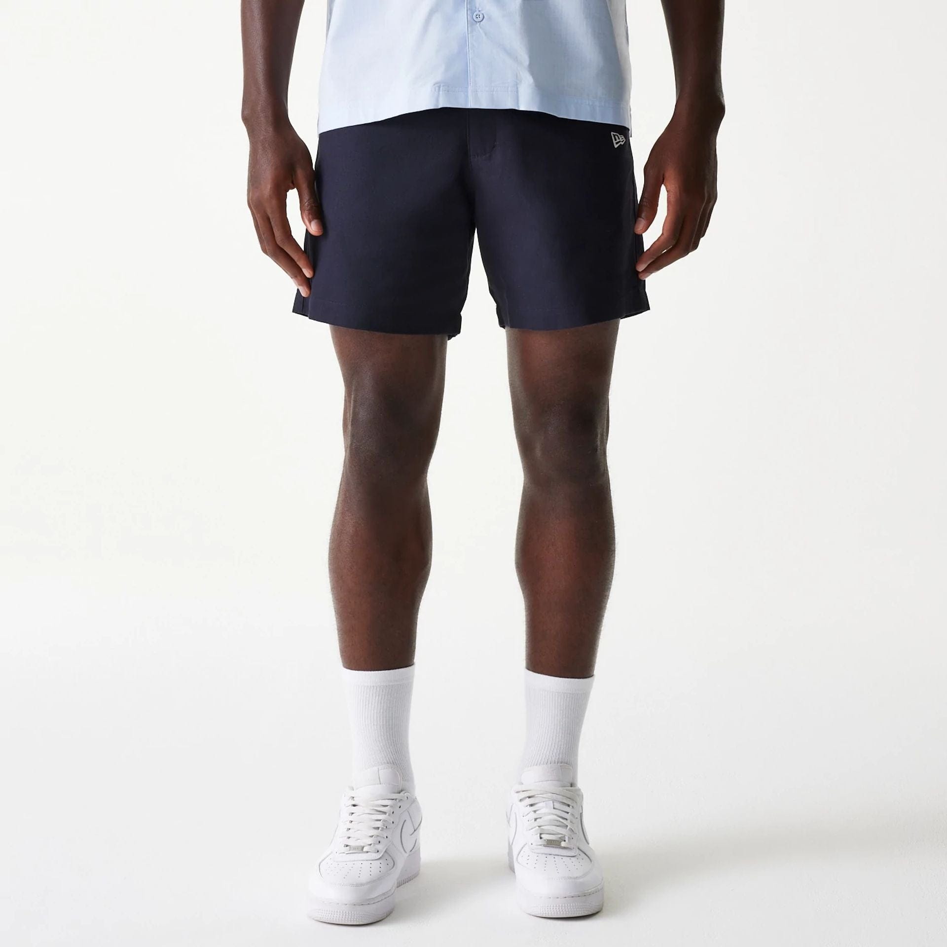 The Male model is wearing New Era Navy Chino Shorts 1