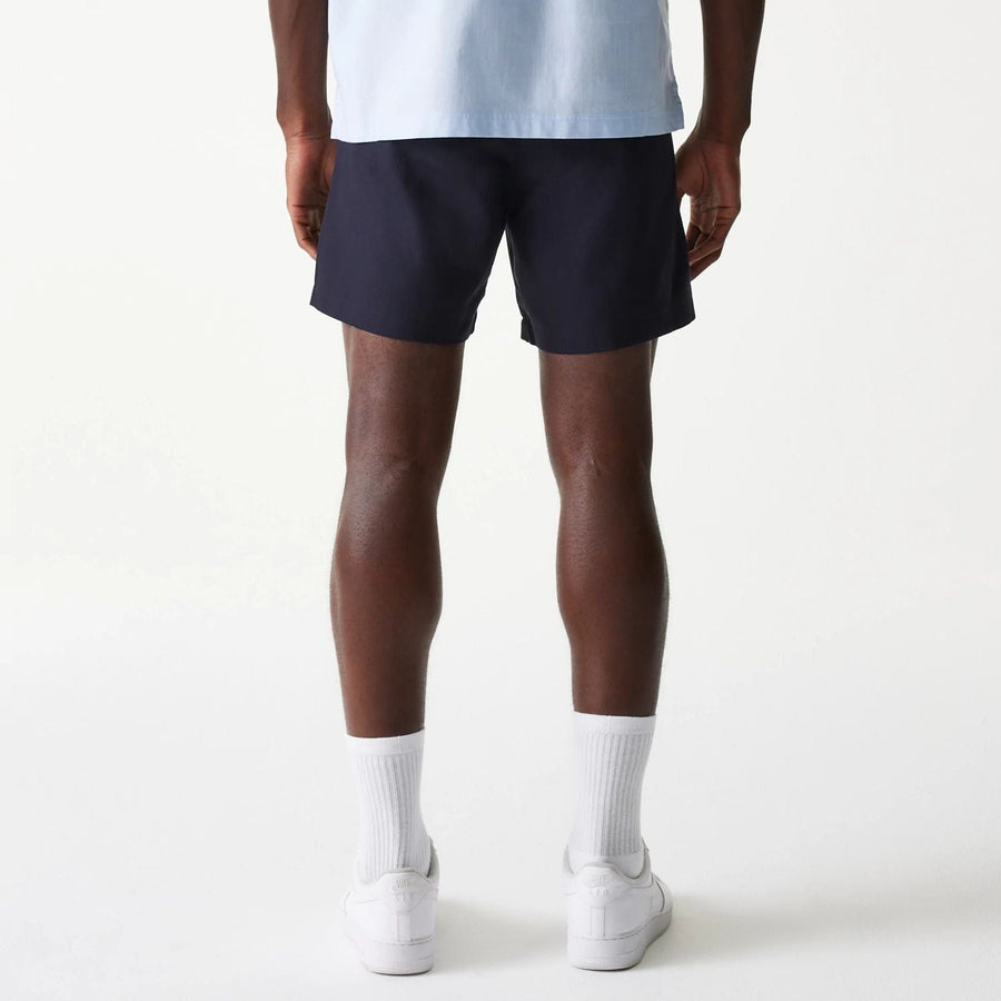 The Male model is wearing New Era Navy Chino Shorts 2