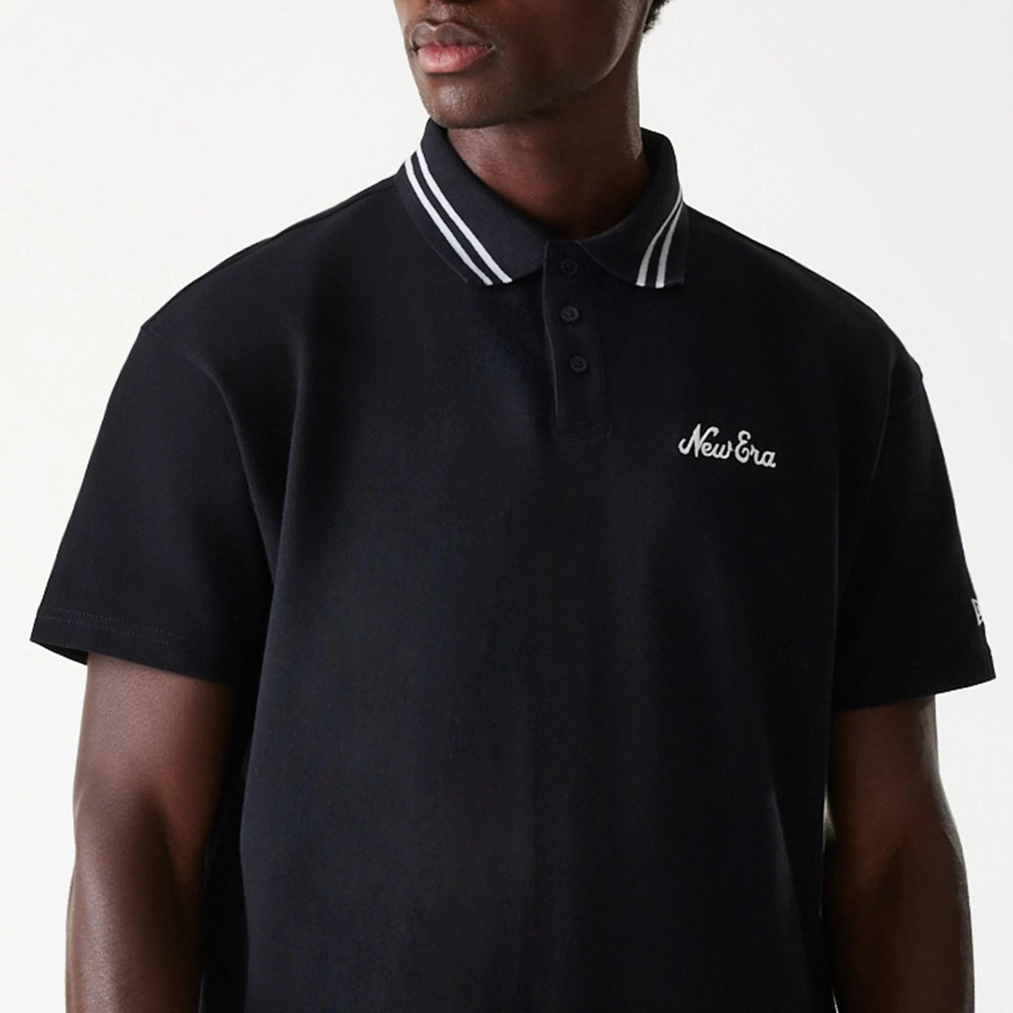 The Male model is wearing New Era Drop Shoulder Black Polo Shirt 4