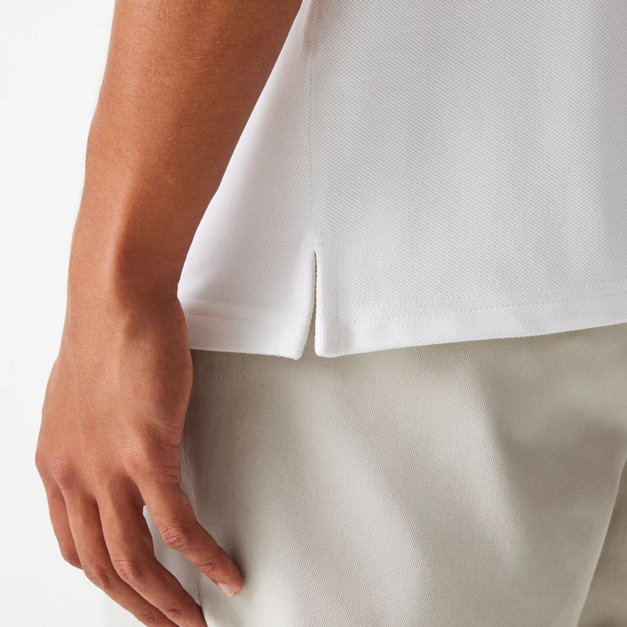 The Male model is wearing New Era Drop Shoulder White Polo Shirt 6