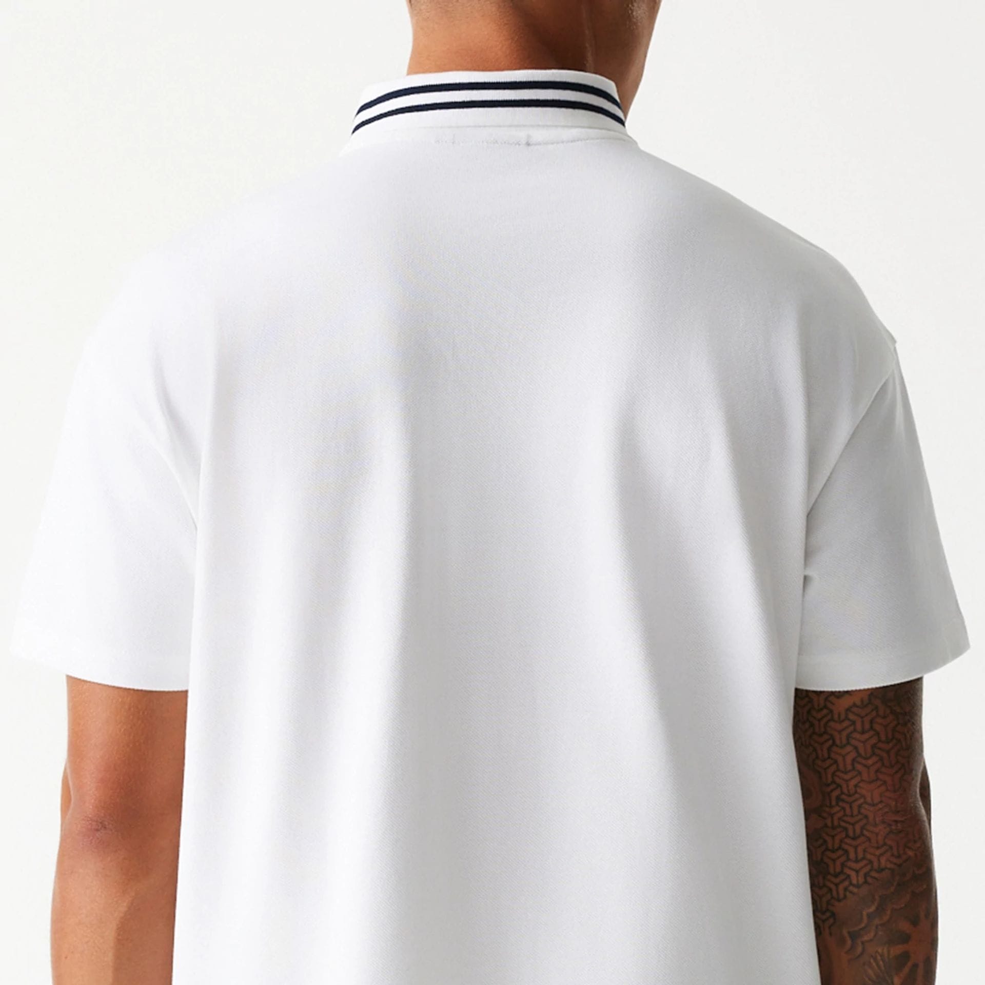 The Male model is wearing New Era Drop Shoulder White Polo Shirt 7