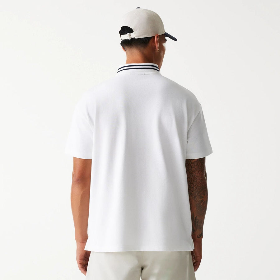 The Male model is wearing New Era Drop Shoulder White Polo Shirt 2