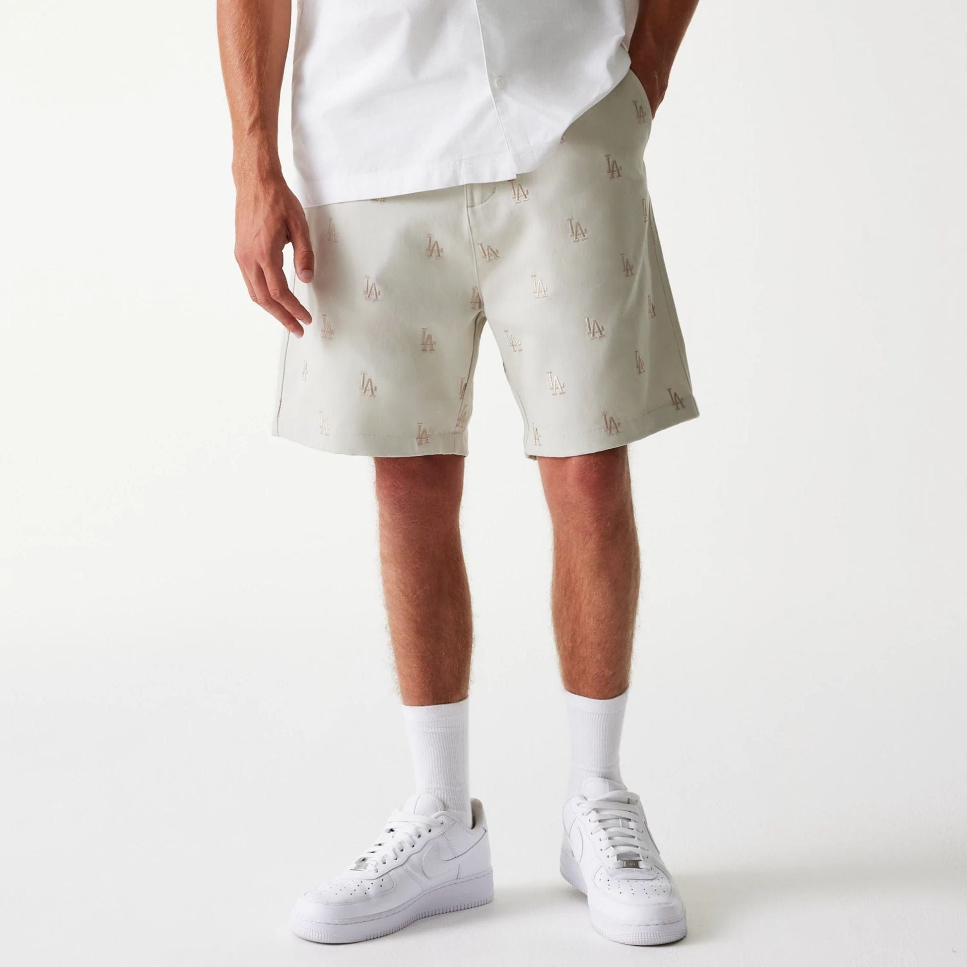 The Male model is wearing LA Dodgers MLB Monogram Cream Shorts 1