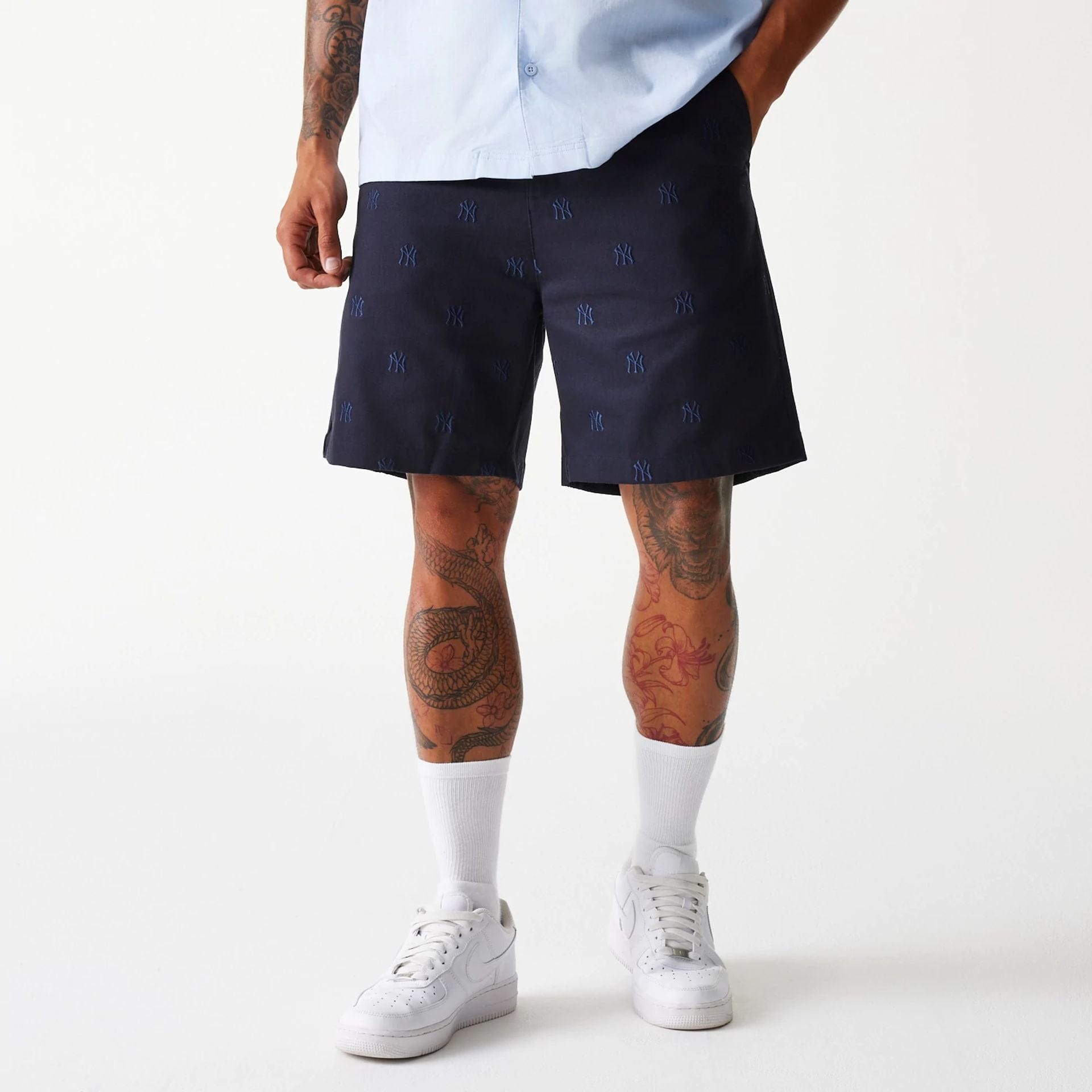 The Male model is wearing New York Yankees MLB Monogram Navy Shorts 1
