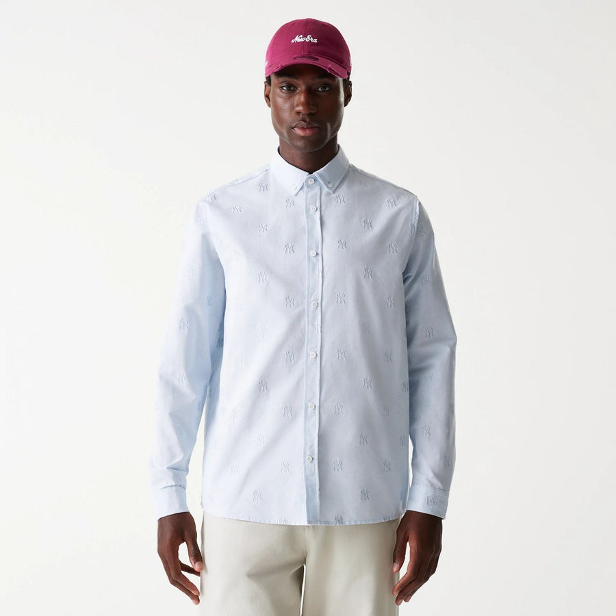 The Male model is wearing New York Yankees MLB Monogram Pastel Blue Long Sleeve Shirt 1