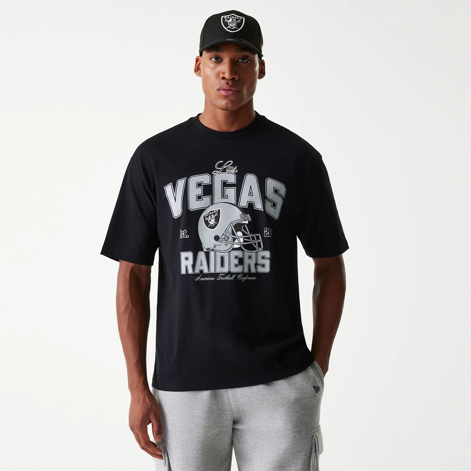 The Male model is wearing Las Vegas Raiders NFL Helmet Black Oversized T-Shirt 1