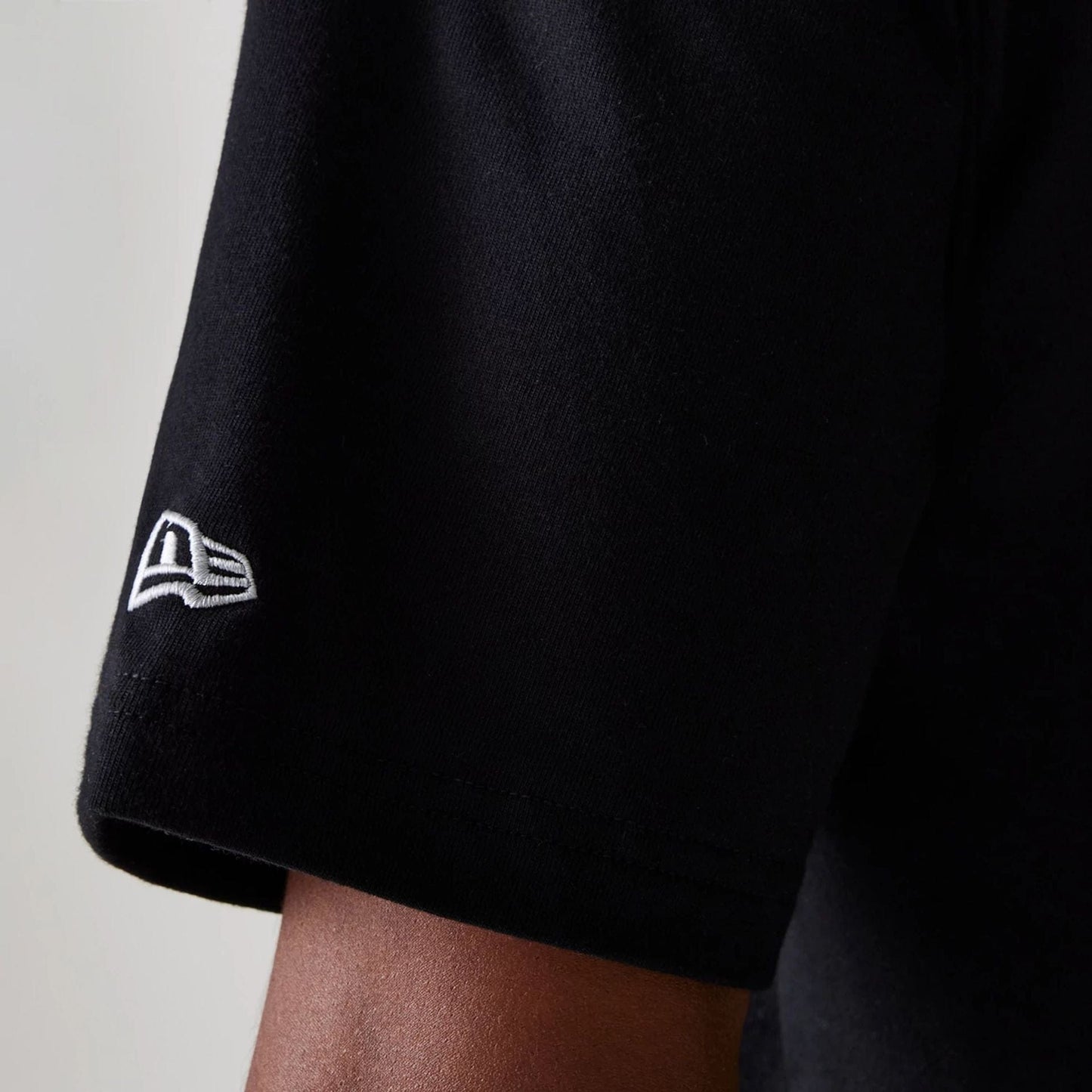 The Male model is wearing Las Vegas Raiders NFL Helmet Black Oversized T-Shirt 5